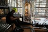 FILE - A worker adjusts cables during the installation of a new organ at Prague's St. Vitus Cathedral that is coming to its final stages in Prague, Czech Republic, Tuesday, July 22, 2025. (AP Photo/Petr David Josek, File)