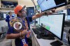 Options trader, and New York Knicks fan Ousama Fayek works on the floor of the New York Stock Exchange, Monday, June 15, 2026. (AP Photo/Richard Drew)
