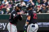 Minnesota Twins' Byron Buxton, left, and Royce Lewis (23) celebrates Buxton's solo home run in the sixth inning of a baseball game against the Texas Rangers in Arlington, Texas, Monday, June 15, 2026. (AP Photo/Tony Gutierrez)