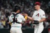 Arizona Diamondbacks catcher Gabriel Moreno (14) and pitcher Paul Sewald celebrate after defeating the Los Angeles Angels during a baseball game, Monday, June 15, 2026, in Phoenix. (AP Photo/Rick Scuteri)