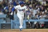 Los Angeles Dodgers' Miguel Rojas watches his home run during the seventh inning of a baseball game against the Tampa Bay Rays, Monday, June 15, 2026, in Los Angeles. (AP Photo/William Liang)