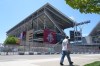 A soccer fan walks past BMO Field, Toronto's FIFA World Cup venue, while construction continues as the countdown to the opening game hits two weeks, in Toronto, Friday, May 29, 2026. THE CANADIAN PRESS/Chris Young