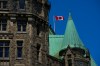 The Canadian flag blows on top of the Confederation Building on Parliament Hill in Ottawa on Tuesday, May 26, 2026. THE CANADIAN PRESS/Sean Kilpatrick