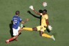 France's Bradley Barcola (12) scores a goal against Senegal goalkeeper Edouard Mendy (16) during the World Cup Group I soccer match between France and Senegal in East Rutherford, N.J., near New York, Tuesday, June 16, 2026. (AP Photo/Pamela Smith)