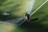 A groundskeeper puts his hand in the sprinkler before the start of the World Cup Group I soccer match between Iraq and Norway in Foxborough, Mass., near Boston, Tuesday, June 16, 2026. (AP Photo/Mark Stockwell)