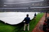 Atlanta Braves grounds crew cover the infield with a tarp after the game was suspended due to weather in the second inning of a baseball game, Tuesday, June 16, 2026, in Atlanta. (AP Photo/Erik S. Lesser)