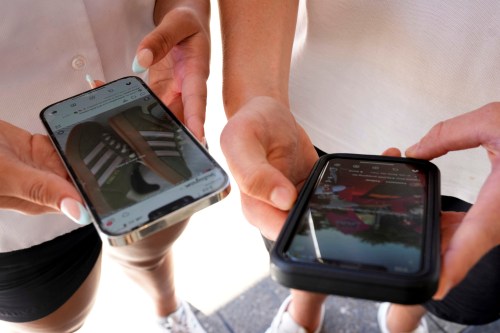 Young people use their phones to view social media in Sydney, Nov. 8, 2024. (AP Photo/Rick Rycroft, File)