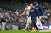 Milwaukee Brewers' Brandon Sproat, left, walks off the field with pitching coach Chris Hook and a trainer after suffering an injury during the fourth inning of a baseball game against the Cleveland Guardians, Wednesday, June 17, 2026, in Milwaukee. (AP Photo/Aaron Gash)