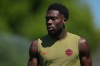 Canada's Alphonso Davies walks across the field during a training session on the eve of the team's World Cup soccer match against Qatar, Wednesday, June 17, 2026, in Vancouver, British Columbia. (AP Photo/Abbie Parr)