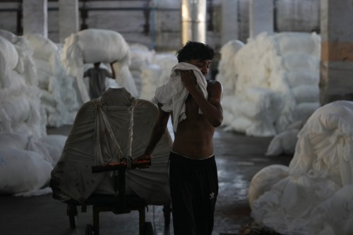 A worker wipes sweat from his face on a hot day at Vinit Fabrics in Palsana near Surat, India, Tuesday, May 26, 2026. (AP Photo/Ajit Solanki)