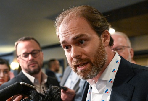 Quebec Liberal delegate Antoine Dionne-Charest, son of former Quebec premier Jean Charest, responds to reporters questions at the Quebec Liberal general council meeting, Saturday, Oct. 14, 2023, in Drummondville, Que. THE CANADIAN PRESS/Jacques Boissinot