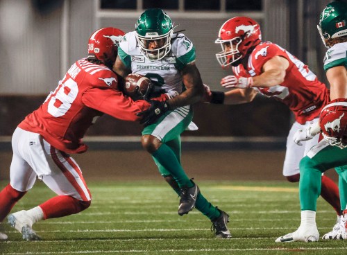 Saskatchewan Roughriders' Mario Alford (2) is tackled by Calgary Stampeders' Adam Konar (38) during first half CFL football action in Calgary, Friday, Sept. 20, 2024.THE CANADIAN PRESS/Jeff McIntosh