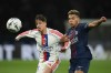 FILE - Lyon's Afonso Moreira, left, and PSG's Desire Doue challenge for the ball during the French League One soccer match between Paris Saint-Germain and Olympique Lyon in Paris on April 19, 2026. (AP Photo/Christophe Ena, File)