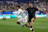 Iran's Mehdi Ghayedi (10) battles for the ball with New Zealand's Tim Payne (2) during the World Cup Group G soccer match between Iran and New Zealand in Inglewood, Calif., near Los Angeles, Monday, June 15, 2026. (AP Photo/Andre Penner)