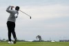 Rory McIlroy, of Northern Ireland, looses his hat in the wind on the 13th hole during the first round of the U.S. Open golf tournament at Shinnecock Hills Golf Club in Southampton, N.Y., Thursday, June 18, 2026.(AP Photo/George Walker IV)
