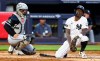 New York Yankees' Jazz Chisholm Jr., right, reacts after fouling a ball off himself during the fourth inning of a baseball game against the Chicago White Sox, Thursday, June 18, 2026, in New York. (AP Photo/Noah K. Murray)