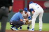 Kansas City Royals shortstop Bobby Witt Jr. talks to manager Matt Quatraro, right, and trainer Kyle Turner, left, after getting injured while fielding a single by St. Louis Cardinals' Jordan Walker during the fourth inning of a baseball game Thursday, June 18, 2026, in Kansas City, Mo. (AP Photo/Charlie Riedel)