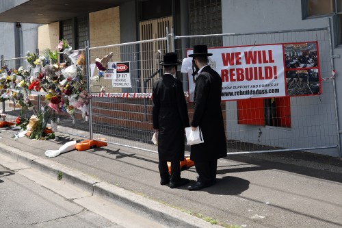 People gather outside the Adass Israel Synagogue, Dec. 9, 2024, after a firebombing in Melbourne, Australia. (Con Chronis/AAP Image via AP)