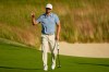 Wyndham Clark waves after his putt on the 18th hole during the first round of the U.S. Open golf tournament at Shinnecock Hills Golf Club in Southampton, N.Y., Thursday, June 18, 2026.(AP Photo/Gerald Herbert)