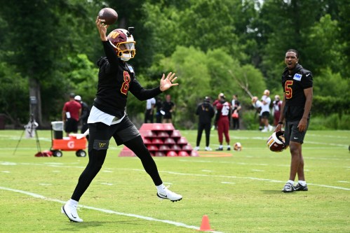 Washington Commanders quarterback Marcus Mariota (8) works out next to quarterback Jayden Daniels (5) during NFL football practice, Tuesday, June 9, 2026, in Ashburn, Va. (AP Photo/Nick Wass)