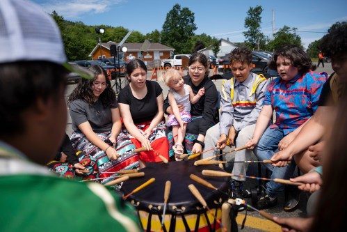 Members of the We’koqma’q Mikmaw school drum group White Bear practise before an event for National Indigenous Peoples Day in We'koqma'q First Nation, N.S., on Friday, June 21, 2024. THE CANADIAN PRESS/Darren Calabrese