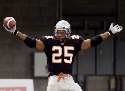 BC Lions Sean Millington (25) celebrates one of two touchdowns he scored in the second quarter of CFL action against the Hamilton Tiger-Cats in Vancouver Thursday, July 18, 2002. The Lions led 23-14 at the half. (CP PHOTO/Richard Lam)