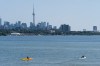 The CN Tower looms in the distance as a pair of kayakers paddle on Lake Ontario in Toronto, on Tuesday, Aug. 22, 2023. THE CANADIAN PRESS/Spencer Colby