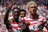 United States' Folarin Balogun (20) and Antonee Robinson (5) celebrate after scoring during the World Cup Group D soccer match between the United States and Australia in Seattle, Friday, June 19, 2026. (AP Photo/Ted S. Warren)