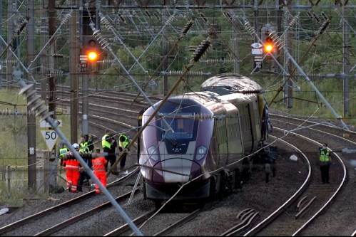 Emergency personnel work on a train on the tracks outside Bedford, England, after a train from Corby to London St. Pancras and another from Nottingham to London St. Pancras, collided on Friday June 19, 2026. (Jamie Lashmar/PA via AP)