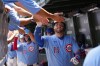 Chicago Cubs' Carson Kelly (15) is greeted in the dugout after hitting grand slam homer against the Toronto Blue Jays during the first inning of a baseball game Friday, June 19, 2026, in Chicago. (AP Photo/David Banks)