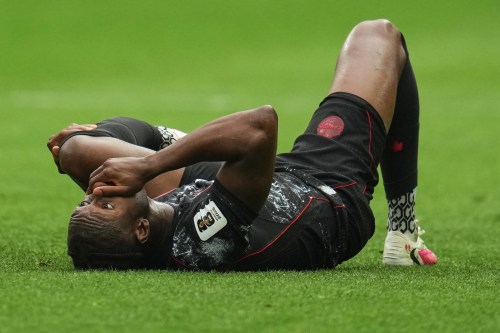 Canada's Ismael Kone reacts on the ground after sustaining an injury during the World Cup Group B soccer match against Qatar in Vancouver on June 18, 2026. (AP Photo/Abbie Parr)
