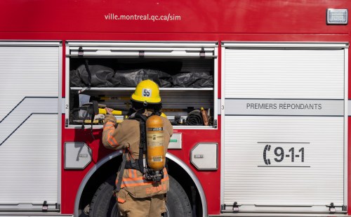 A firefighter puts gear away after responding to an alarm in Pointe Claire, a borough of Montreal, Thursday March 7, 2024. THE CANADIAN PRESS/Christinne Muschi