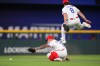 Texas Rangers center fielder Josh Smith (8) jumps over left fielder Cody Freeman, left, allowing a double by Minnesota Twins Kody Clemens during the 8th inning of a baseball game, Tuesday, June 16, 2026, in Arlington, Texas. (AP Photo/LM Otero)