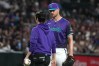 Arizona Diamondbacks pitcher Michael Soroka, right, talks to a trainer, left, in the second inning of a baseball game against the Minnesota Twins, Friday, June 19, 2026, in Phoenix. (AP Photo/Rick Scuteri)