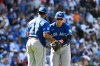 Toronto Blue Jays first baseman Vladimir Guerrero Jr. (27) and third baseman Kazuma Okamoto, right, of Japan, hug after a baseball game against the Chicago Cubs, Saturday, June 20, 2026, in Chicago. (AP Photo/Matt Marton)