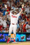 Philadelphia Phillies' Bryce Harper reacts to hitting a triple for the cycle during the fifth inning of a baseball game against the New York Mets, Saturday, June 20, 2026, in Philadelphia. (AP Photo/Chris Szagola)