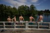 Young boys prepare to dive in the Seine river, in Samois-sur-Seine, south of Paris, Friday, June 19, 2026. (AP Photo/Thibault Camus)