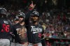 Minnesota Twins' Byron Buxton (25) celebrates after hitting a grand slam with teammates Josh Bell (56) and Ryan Kreidler (5) in the fifth inning of a baseball game against Arizona Diamondbacks Saturday, June 20, 2026, in Phoenix. (AP Photo/Darryl Webb)