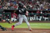 Minnesota Twins' Byron Buxton, right, hits a grand slam in the fifth inning against the Arizona Diamondbacks during a baseball game Saturday, June 20, 2026, in Phoenix. (AP Photo/Darryl Webb)