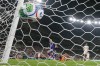 Japan's Junya Ito (14) scores their third goal past Tunisia goalkeeper Aymen Dahmen (16) during the World Cup Group F soccer match between Tunisia and Japan in Guadalupe, near Monterrey, Mexico, Saturday, June 20, 2026. (AP Photo/Dolores Ochoa)