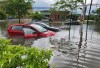 Abandoned cars sit on a flooded street in Montreals west island borough of Pointe Claire during a severe rainstorm on Saturday June 20, 2026. Local roads and highway 40 were closed during the downpour. THE CANADIAN PRESS/Peter McCabe