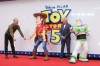 Tom Hanks, left, and Tim Allen pose for photographers with people costumed as the characters Woody and Buzz Lightyear upon arrival at a launch event for the film 'Toy Story 5' on Thursday, May 28, 2026, in London. (Photo by Millie Turner/Invision/AP)