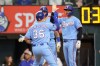 Texas Rangers' Wyatt Langford (36) celebrates at home plate with Kyle Higashioka, right, and Josh Jung, back left, after hitting a three-run home run during the third inning of a baseball game against the San Diego Padres, Sunday, June 21, 2026, in Arlington, Texas. (AP Photo/Gareth Patterson)
