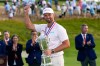 Wyndham Clark holds the trophy after winning the U.S. Open golf tournament at Shinnecock Hills Golf Club in Southampton, N.Y., Sunday, June 21, 2026. (AP Photo/David J. Phillip)