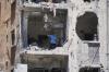 A woman walks through her apartment damaged in Israeli strikes in the southern port city of Tyre, Lebanon, Thursday, June 18, 2026. (AP Photo/Hassan Ammar)