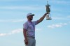 Wyndham Clark holds the trophy after winning the U.S. Open golf tournament at Shinnecock Hills Golf Club in Southampton, N.Y., Sunday, June 21, 2026. (AP Photo/Seth Wenig)