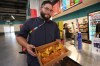 Lazaro Luya, the concession chef at Sol Cubano, displays their special, pan with lechon and fresh mariquitas at Miami Stadium Sunday, June 21, 2026, in Miami Gardens, Fla. (AP Photo/Marta Lavandier)