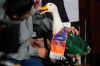 Christian Gomez interacts with his duck Merlin, dressed in a Mexican national soccer team jersey, as they attend the daily press conference by Mexican President Claudia Sheinbaum at the National Palace in Mexico City, Monday, June 22, 2026. (AP Photo/Marco Ugarte)