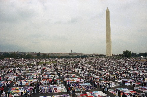 FILE — Thousands of people examine the individual panels of the AIDS quilt as it is displayed on the Mall in Washington on Oct. 11, 1992. (AP Photo/Stephen R. Brown, File)