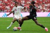Qatar's Alhashmi Alhussein, left, challenges for the ball with Canada's Moise Bombito during the World Cup Group B soccer match in Vancouver, British Columbia, Thursday, June 18, 2026. (AP Photo/Abbie Parr)